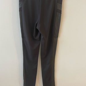 Black pants with faux leather accents. Never worn no tags